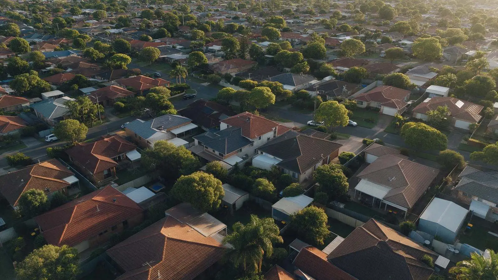 Aerial view of Australian suburban homes at golden hour, property equity for business loans