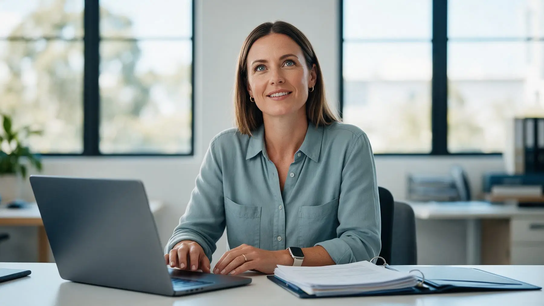 Australian credit assessor reviewing a business loan application at her desk